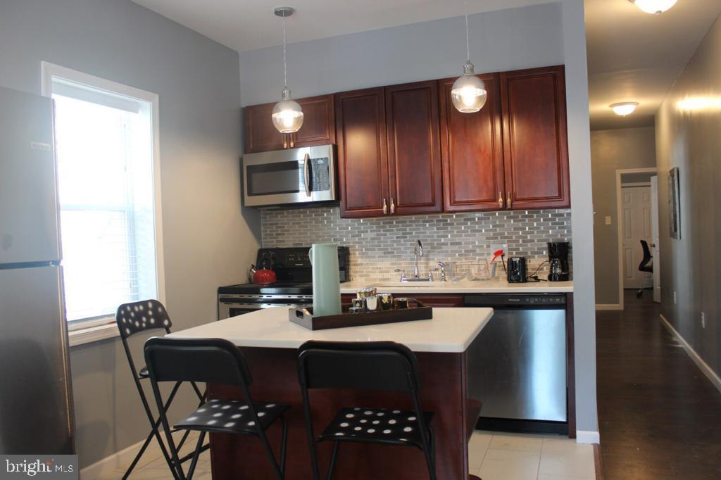 5923 North Broad Street, Unit 1 Philadelphia, PA 19141 - Photo 12 of 25 a kitchen with a sink cabinets and microwave