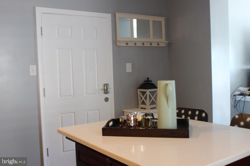 5923 North Broad Street, Unit 1 Philadelphia, PA 19141 - Photo 14 of 25 a room with a white cabinets and chandelier