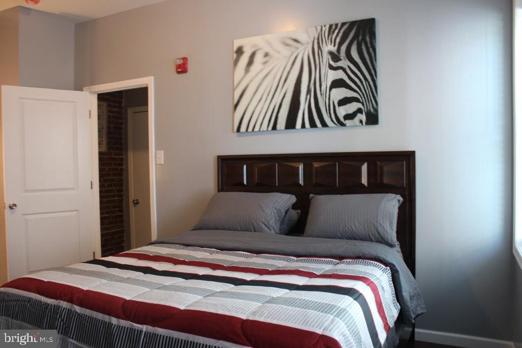 5923 North Broad Street, Unit 1 Philadelphia, PA 19141 - Photo 17 of 25 a bedroom with a bed and painting on the wall