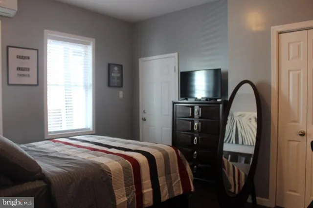 a bedroom with a bed and a flat tv screen