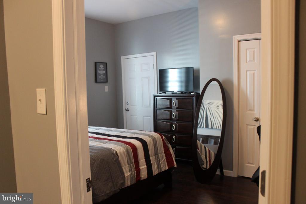 5923 North Broad Street, Unit 1 Philadelphia, PA 19141 - Photo 20 of 25 a bedroom with a bed and a mirror