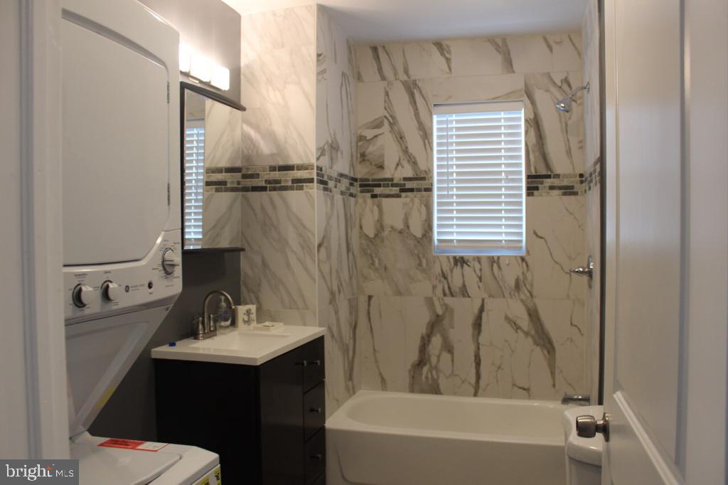 5923 North Broad Street, Unit 1 Philadelphia, PA 19141 - Photo 22 of 25 a bathroom with a sink a toilet and shower