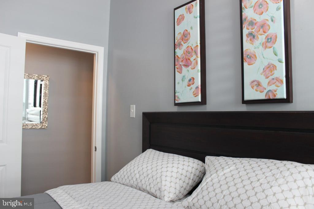 5923 North Broad Street, Unit 1 Philadelphia, PA 19141 - Photo 24 of 25 a bedroom with a bed and painting on the wall