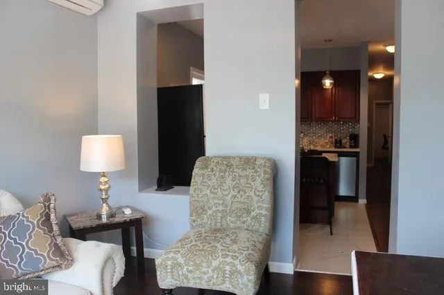 a living room with furniture and a lamp