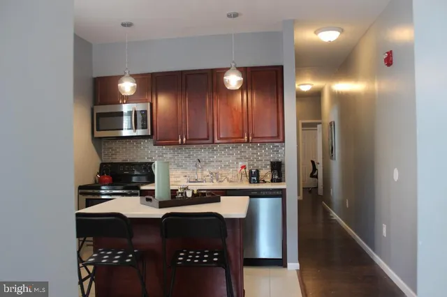 a kitchen with a sink cabinets and stainless steel appliances