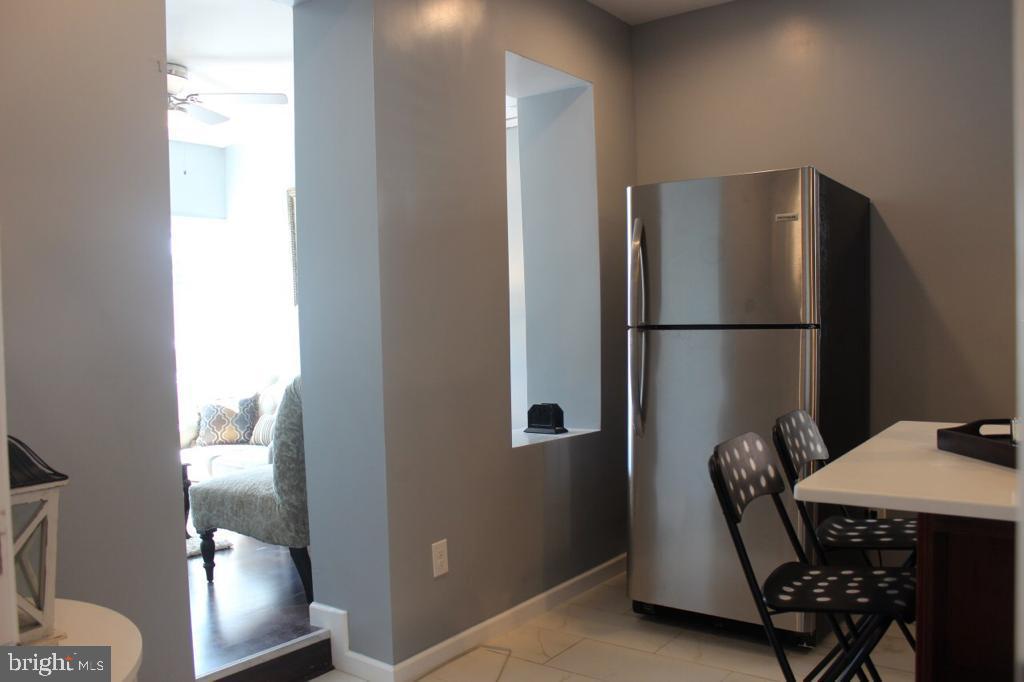 5923 North Broad Street, Unit 1 Philadelphia, PA 19141 - Photo 9 of 25 a kitchen with a refrigerator and washer