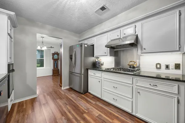 a kitchen with a sink stove and cabinets