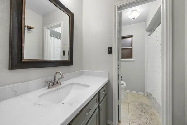a bathroom with a sink a toilet and vanity