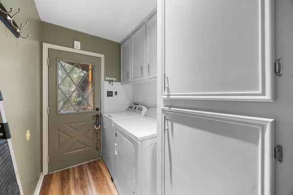a view of a house with a yard and potted plants