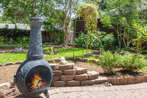 a front view of a house with a yard and sitting area