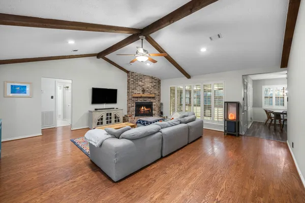 a living room with fireplace furniture and a flat screen tv