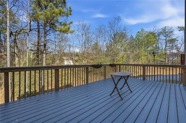 a view of balcony with wooden floor and seating space