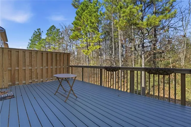 a view of balcony with wooden floor and outdoor seating
