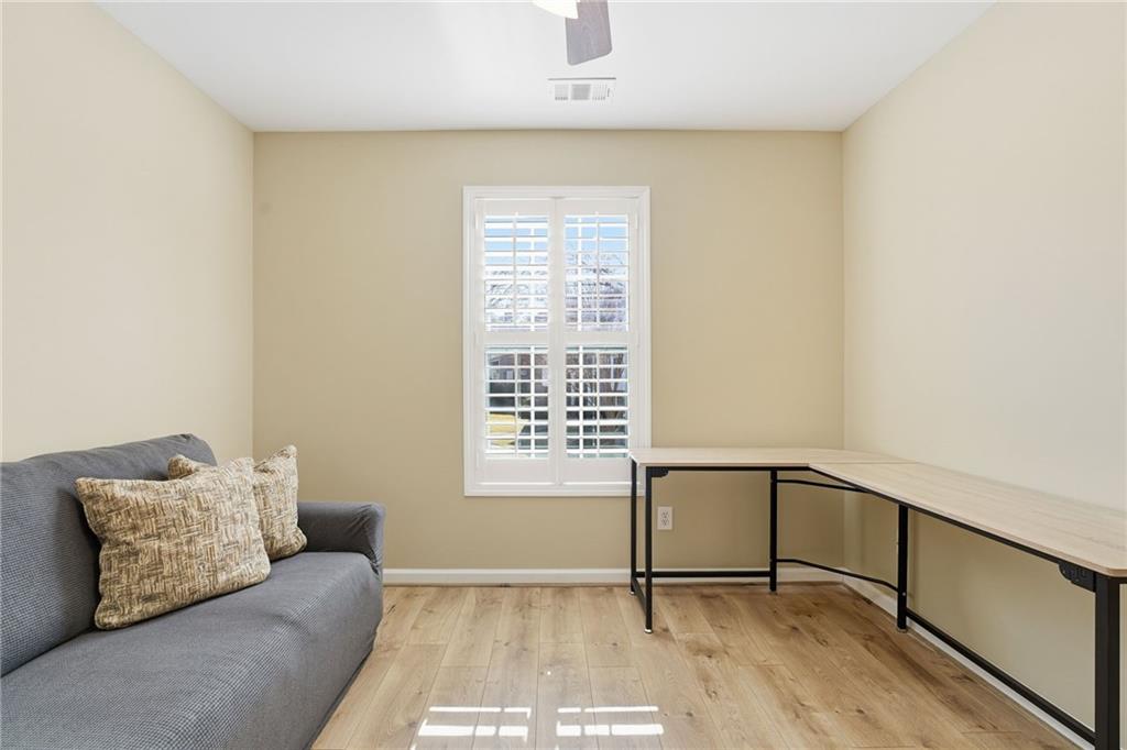 1440 Ferocity Ridge Way Northwest, Unit 17 Kennesaw, GA 30152 - Photo 20 of 42 a living room with a couch and a window