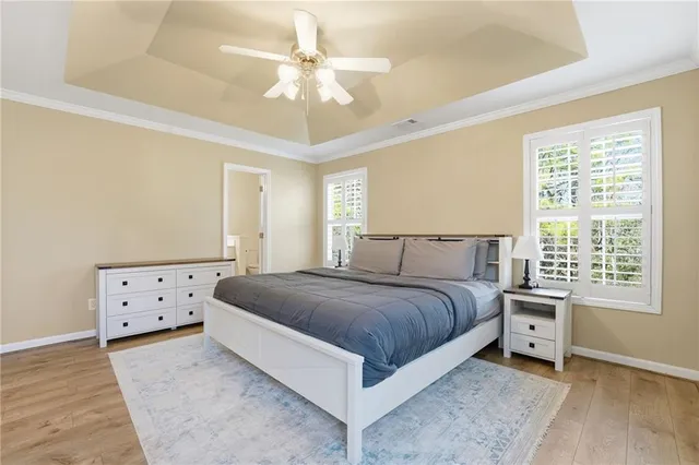 a spacious bedroom with a bed and a chandelier