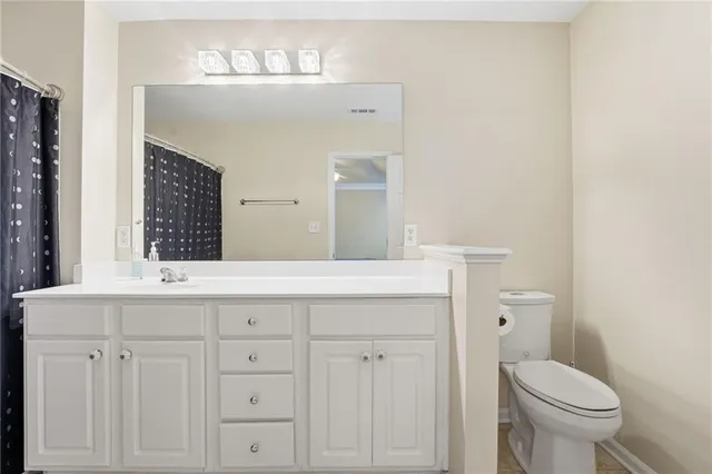 a bathroom with a sink a toilet and mirror