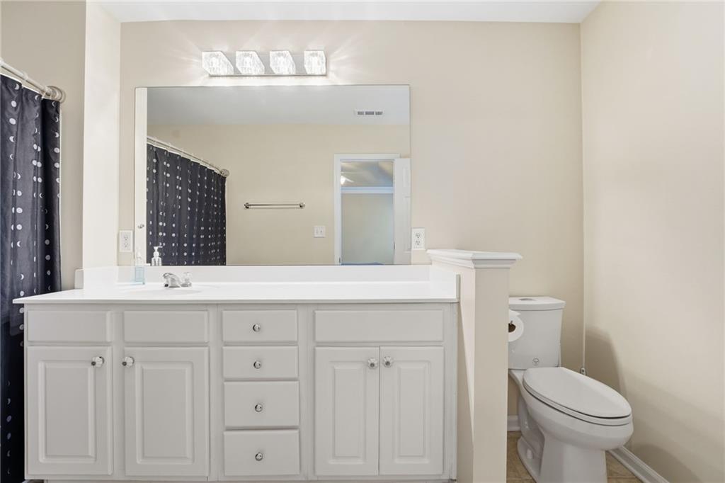 1440 Ferocity Ridge Way Northwest, Unit 17 Kennesaw, GA 30152 - Photo 29 of 42 a bathroom with a sink a toilet and mirror