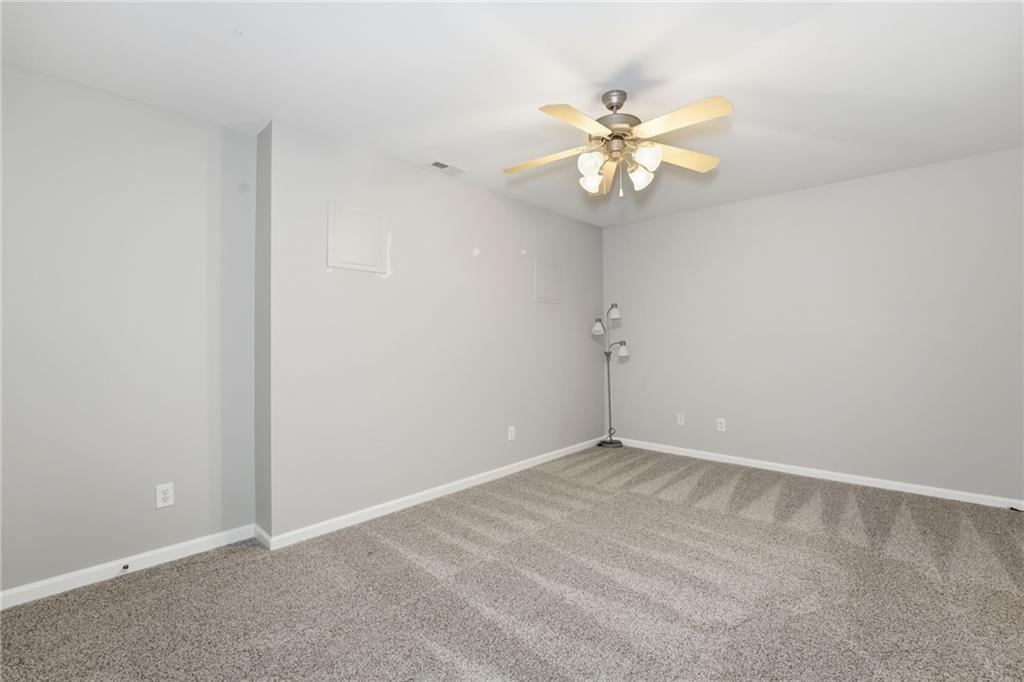 1440 Ferocity Ridge Way Northwest, Unit 17 Kennesaw, GA 30152 - Photo 31 of 42 an empty room with windows and fan