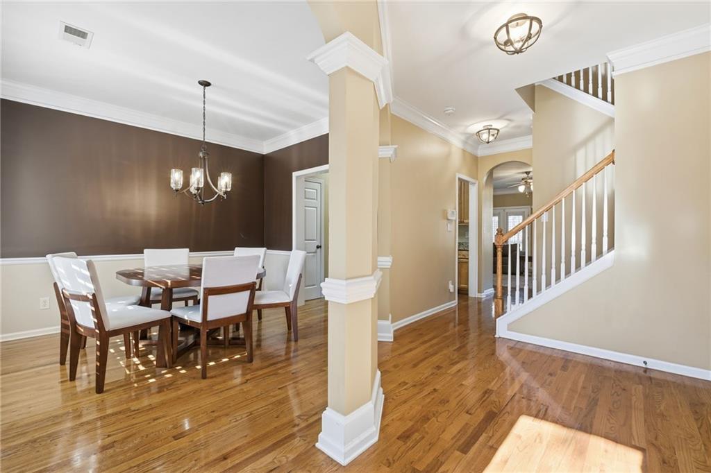 1440 Ferocity Ridge Way Northwest, Unit 17 Kennesaw, GA 30152 - Photo 5 of 42 a view of a dining room with furniture and wooden floor