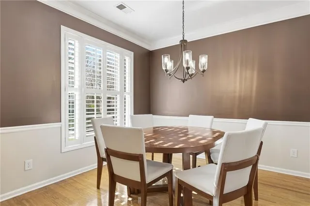 a view of a dining room with furniture wooden floor and chandelier