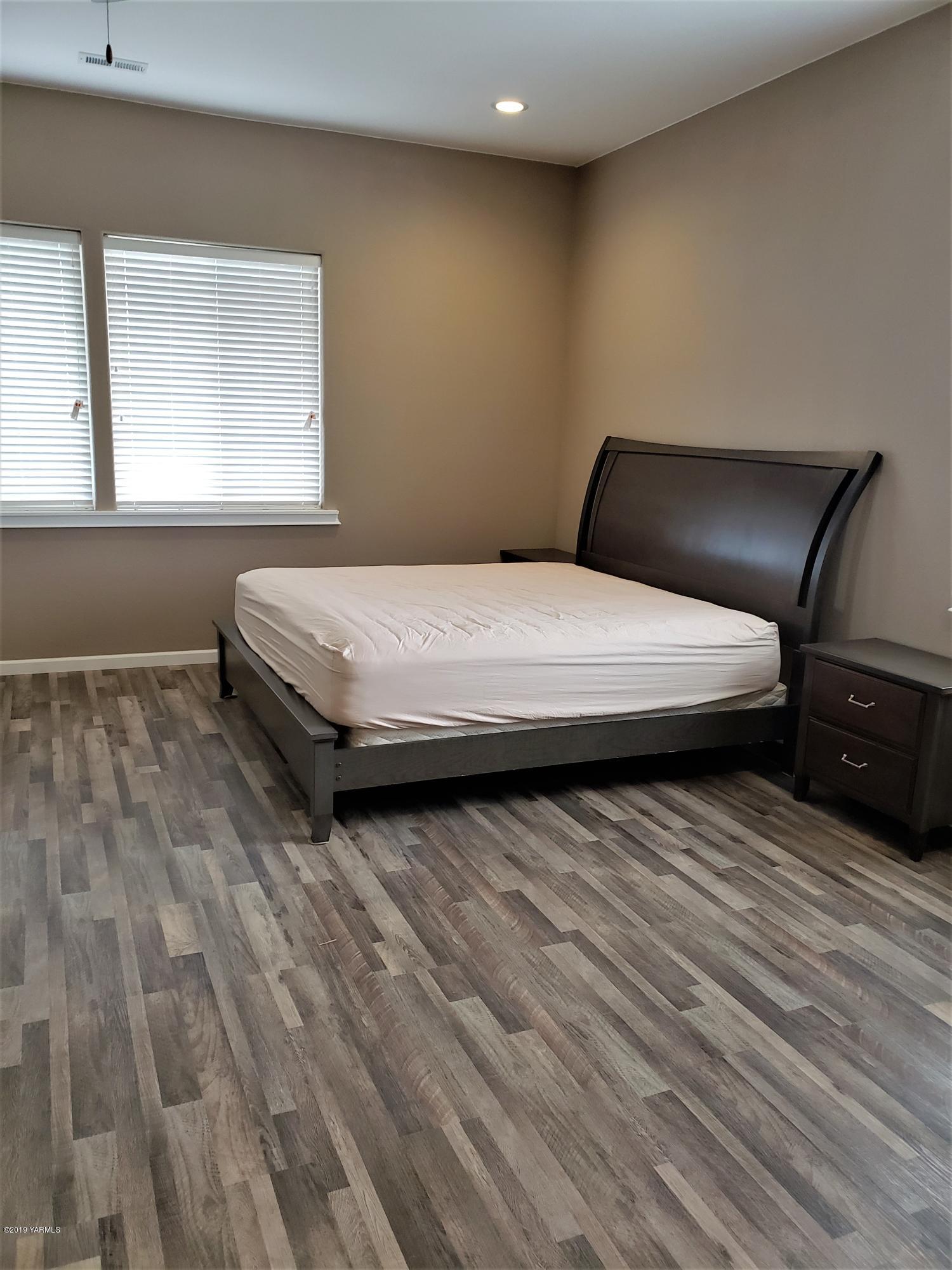 1201 Northwest Crescent Road Sunnyside, WA 98944 - Photo 15 of 35 a bedroom with a bed and wooden floor