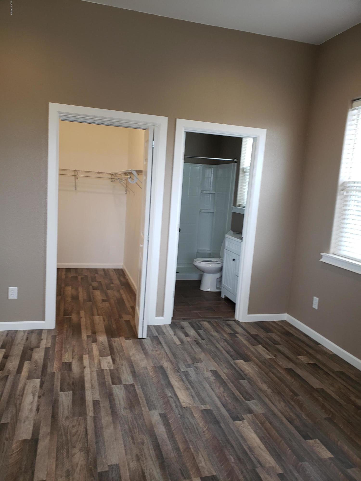 1201 Northwest Crescent Road Sunnyside, WA 98944 - Photo 18 of 35 a view of a room with wooden floor and a bathroom