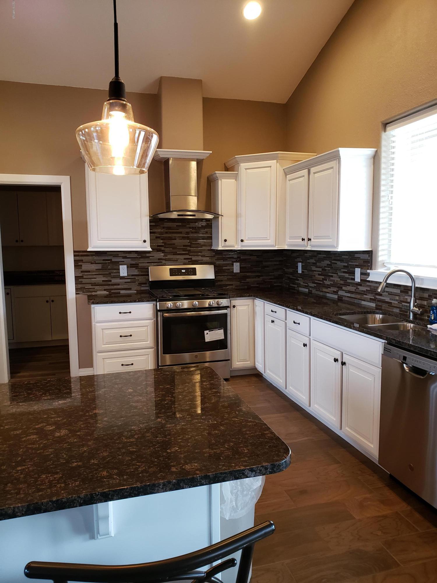 1201 Northwest Crescent Road Sunnyside, WA 98944 - Photo 5 of 35 a kitchen with stainless steel appliances granite countertop a stove a sink and a microwave