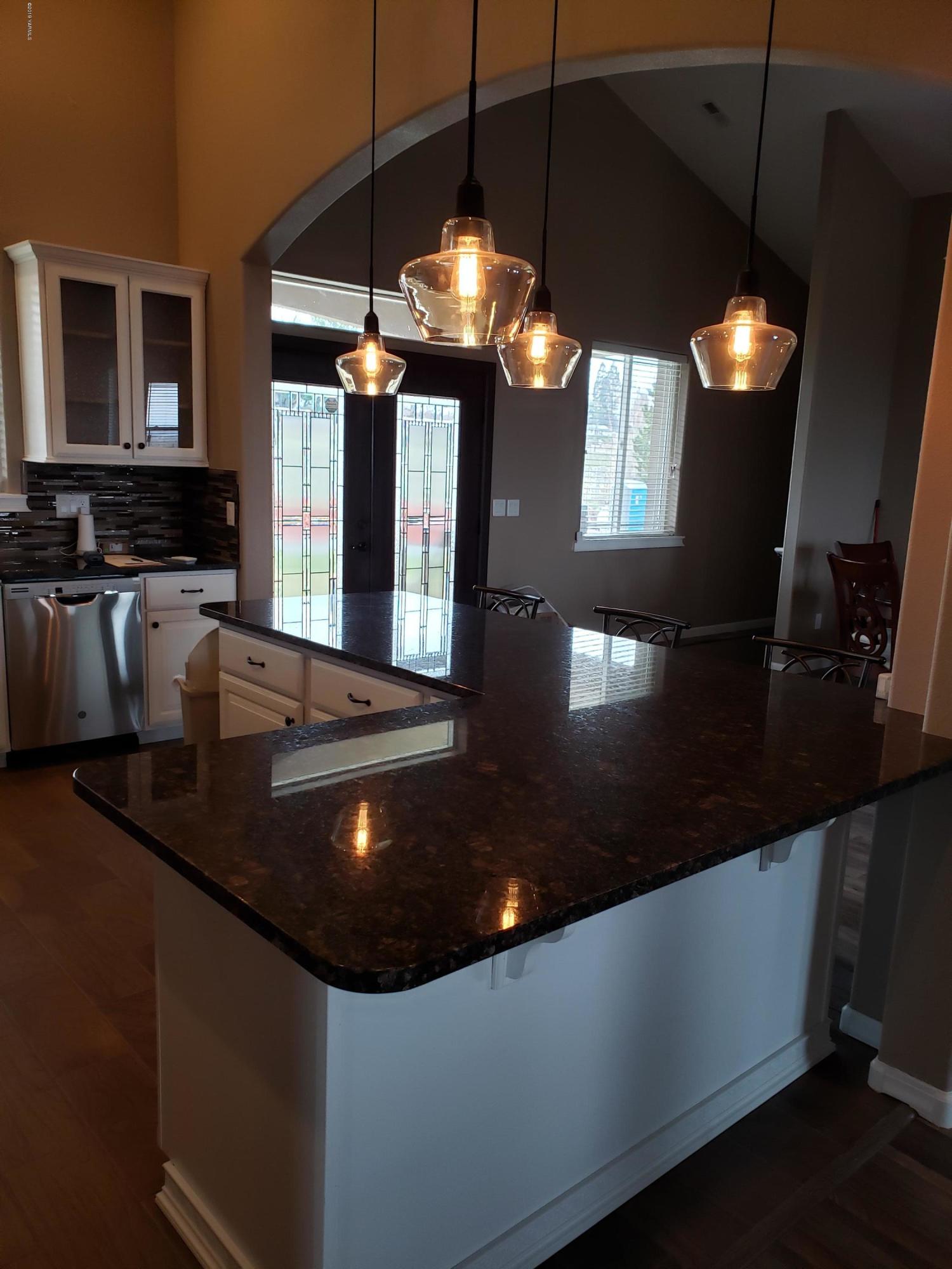 1201 Northwest Crescent Road Sunnyside, WA 98944 - Photo 6 of 35 a kitchen with stainless steel appliances granite countertop a sink a stove and a microwave oven
