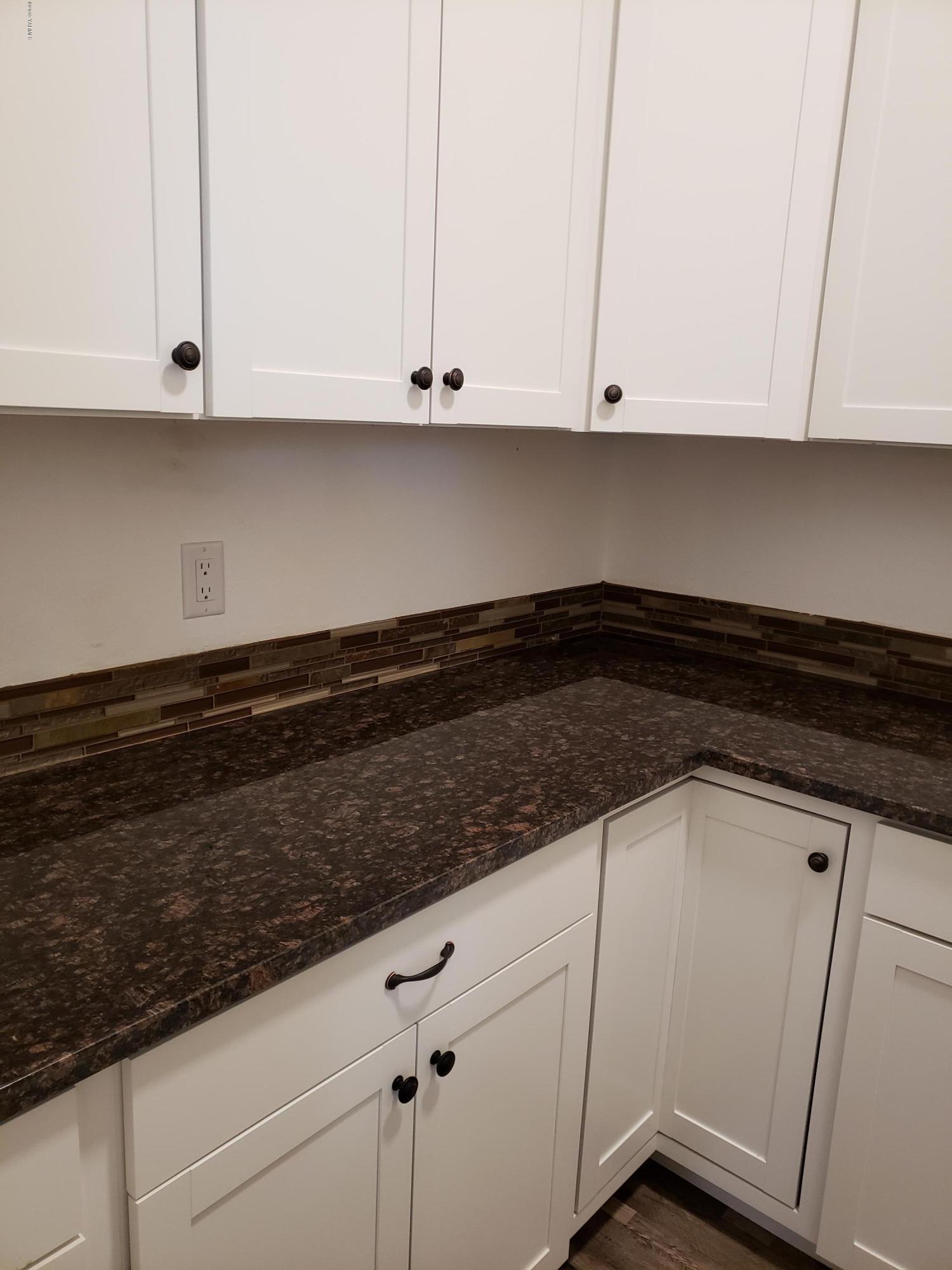 1201 Northwest Crescent Road Sunnyside, WA 98944 - Photo 7 of 35 a kitchen with white cabinets and a sink