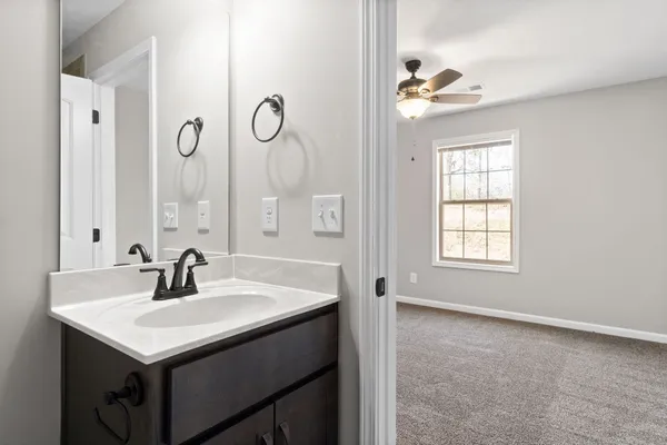 a bathroom with a sink a light fixture and a window