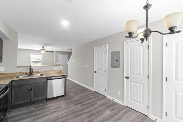 a kitchen with sink cabinets and wooden floor