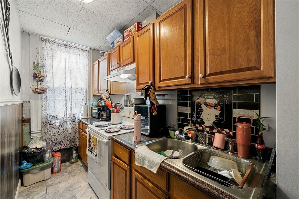 70-72 Russell Street Worcester, MA 01609 - Photo 12 of 30 a kitchen with a sink stove and cabinets