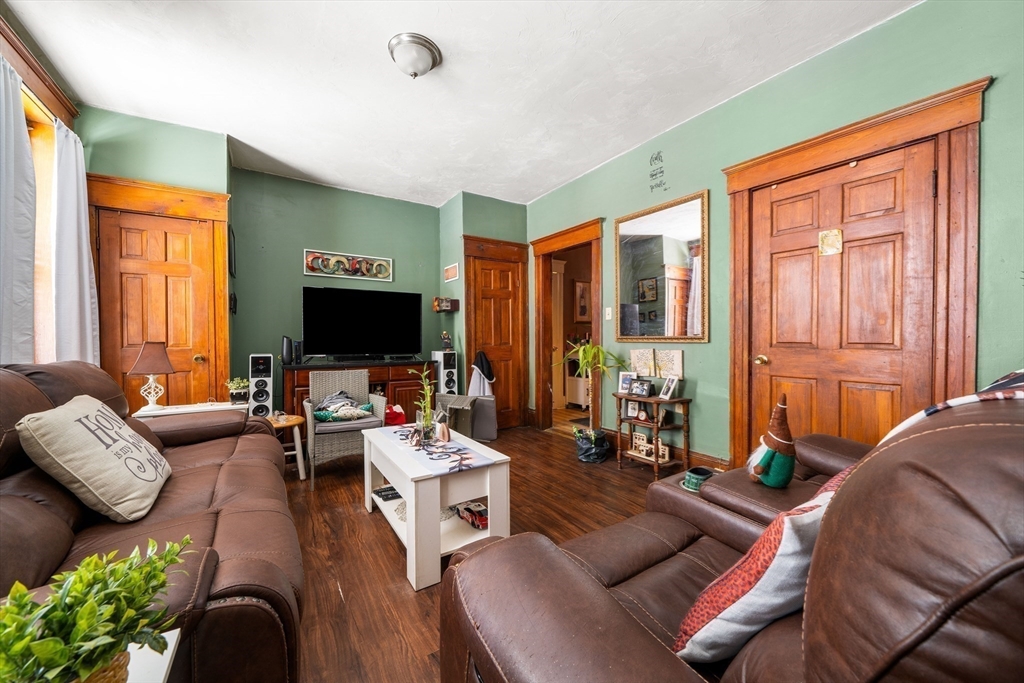 70-72 Russell Street Worcester, MA 01609 - Photo 22 of 30 a living room with furniture flat screen tv and a large window