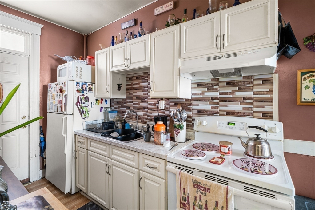 70-72 Russell Street Worcester, MA 01609 - Photo 24 of 30 a kitchen with a sink a stove and cabinets