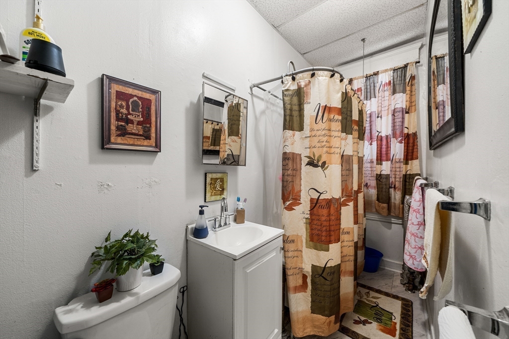 70-72 Russell Street Worcester, MA 01609 - Photo 25 of 30 a bathroom with a shower curtain and a sink