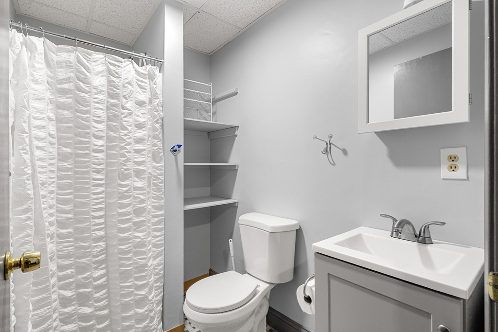 70-72 Russell Street Worcester, MA 01609 - Photo 9 of 30 a white toilet sitting next to a bathroom sink