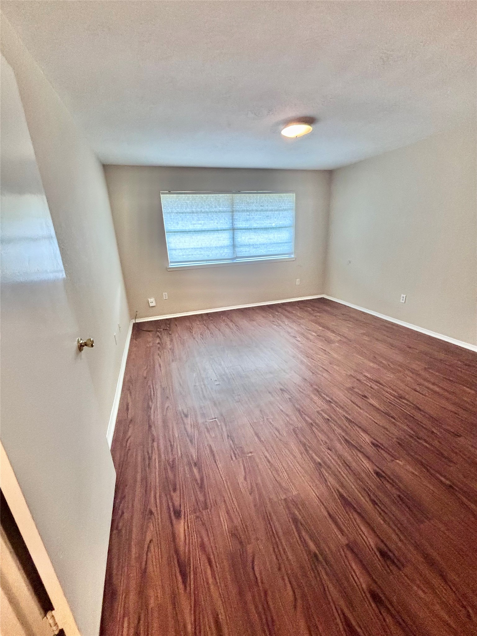 6234 Brookgate Drive Spring, TX 77373 - Photo 8 of 15 an empty room with wooden floor and windows