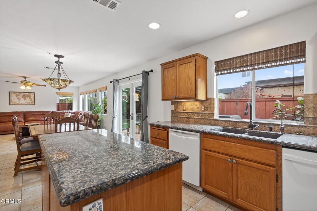 520 Festivo Street Oxnard, CA 93030 - Photo 12 of 31 a kitchen with stainless steel appliances granite countertop sink stove and refrigerator