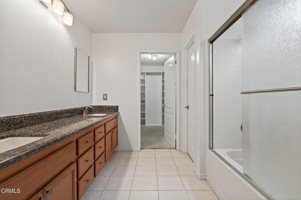 520 Festivo Street Oxnard, CA 93030 - Photo 20 of 31 a spacious bathroom with a granite countertop sink and a mirror