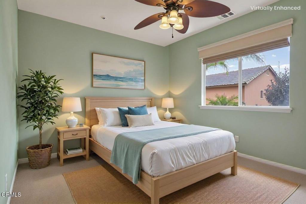 520 Festivo Street Oxnard, CA 93030 - Photo 23 of 31 a bedroom with a large bed and a chandelier