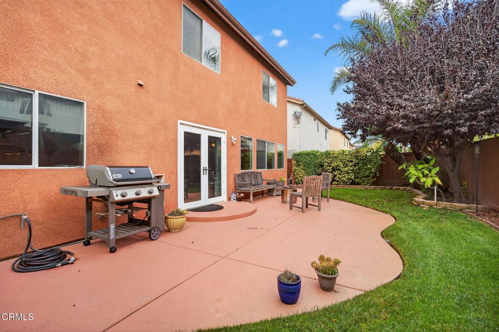 520 Festivo Street Oxnard, CA 93030 - Photo 27 of 31 a view of a patio with table and chairs potted plants and a palm tree