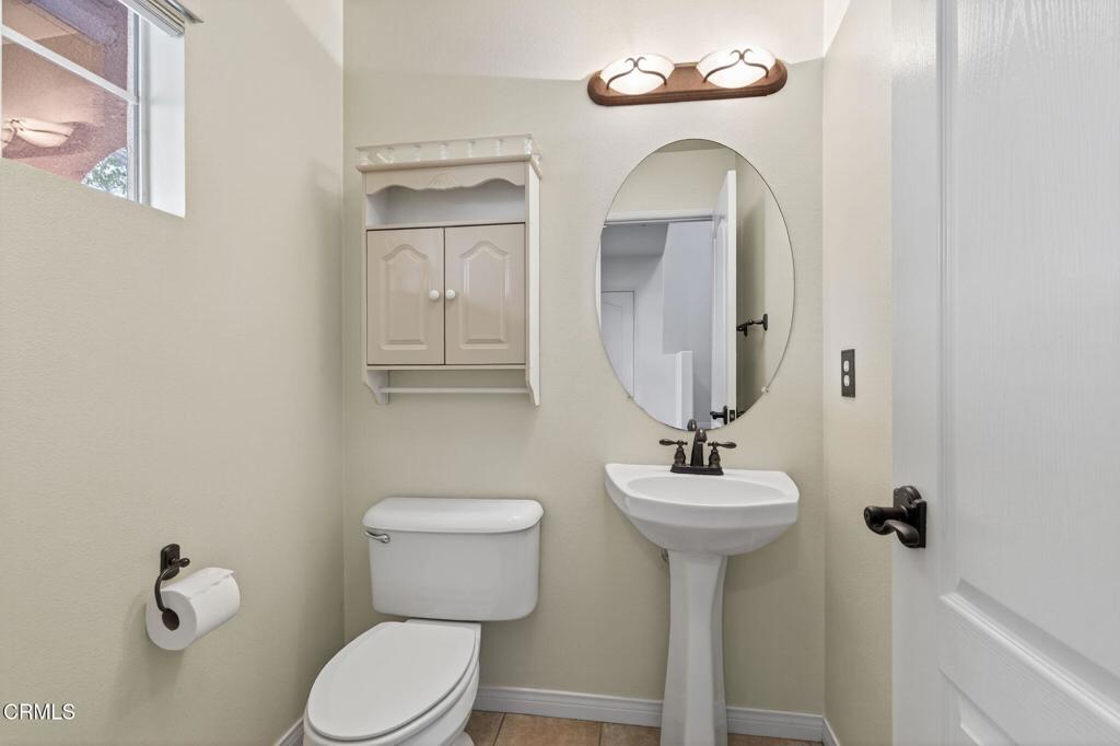 520 Festivo Street Oxnard, CA 93030 - Photo 6 of 31 a bathroom with a toilet sink and mirror