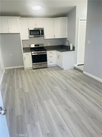 a kitchen with granite countertop a stove and a sink