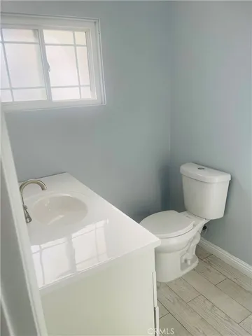 a white toilet sitting next to a bathroom sink
