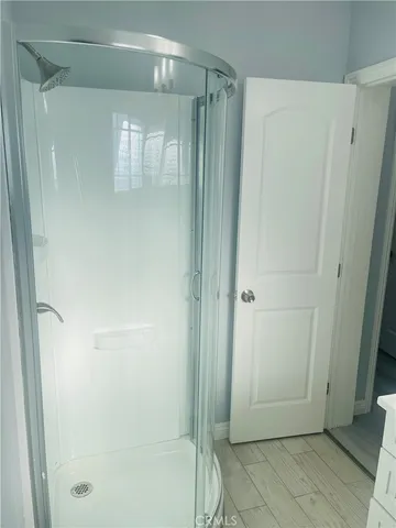 a bathroom with a glass shower door