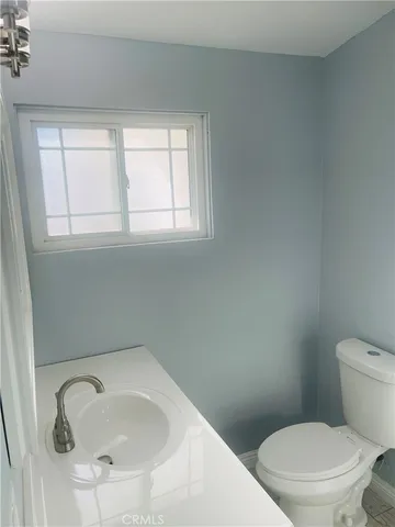 a white toilet sitting next to a bathroom sink