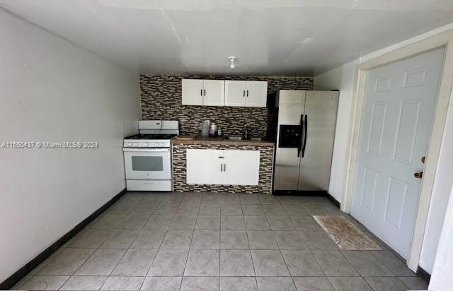 29605 Southwest 154th Court Homestead, FL 33033 - Photo 11 of 25 a kitchen with white cabinets and white appliances