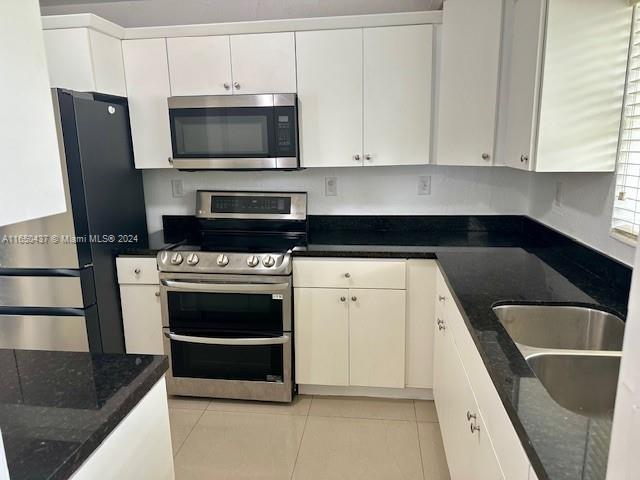 29605 Southwest 154th Court Homestead, FL 33033 - Photo 3 of 25 a kitchen with stainless steel appliances a stove a microwave and a sink