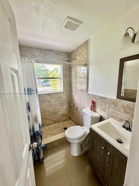 29605 Southwest 154th Court Homestead, FL 33033 - Photo 5 of 25 a bathroom with a double vanity sink toilet mirror and tub