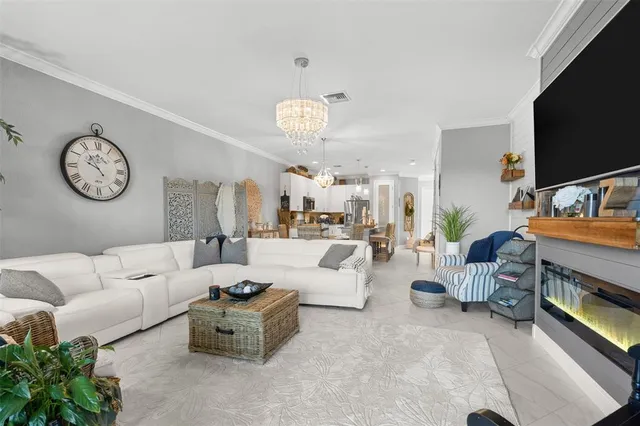 a living room with furniture a flat screen tv and a clock